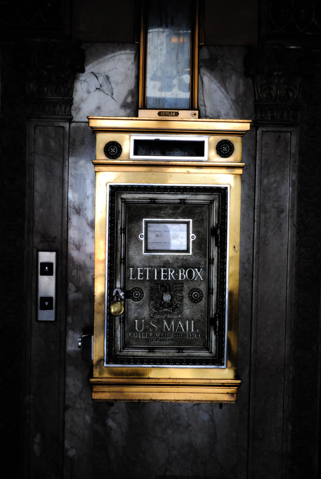 A black and gold mailbox