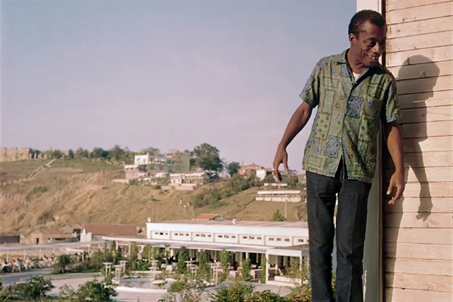 James Baldwin standing on a hotel balcony in Turkey