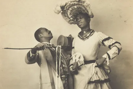 No known photographs of Swann survive. This 1903 postcard depicts two Black actors, one of whom is dressed in drag, performing a cakewalk in Paris.