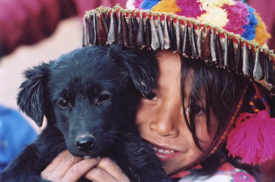 Matchua, a young Wixárika (Huichol) boy, with a black puppy