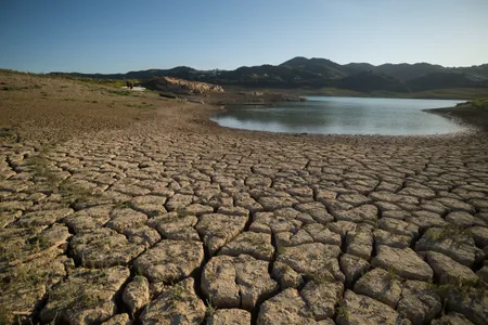 Dry and cracked ground at the La Vinuela reservoir near M&aacute;laga, Spain, last year. Reservoirs in the country&#39;s Catalonia region have fallen to 16 percent capacity amid years of drought and extreme heat.
