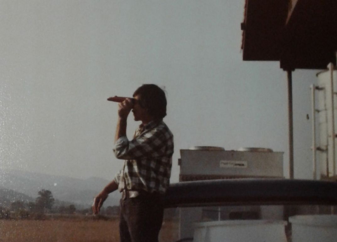 Gustavo Brambila looking through a refractometer