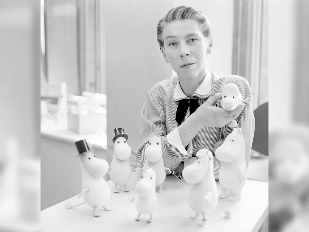 Tove Jansson with several Moomin dolls