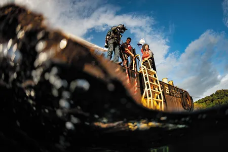 OPENER - A diver prepares to enter the water of Malakal Harbor in Palau, where the plane flown by U.S. Navy pilot Jay Ross Manown Jr. was shot down in September 1944.